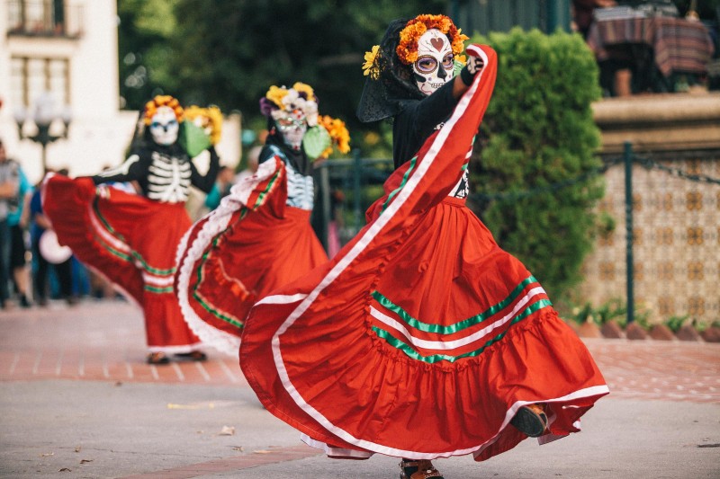 A photo of a girl dancing during Dia de los Muertos