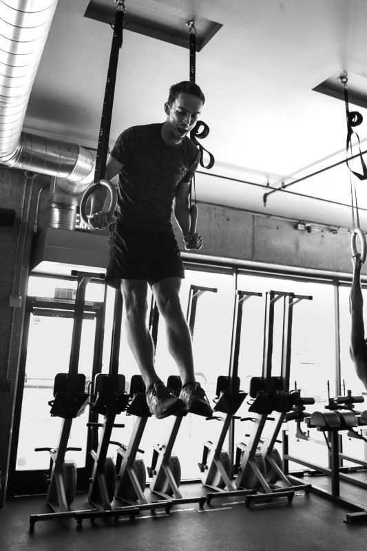A photo of a man getting his first muscle up